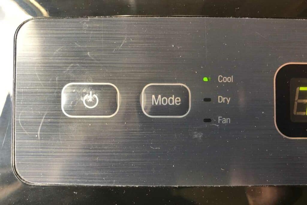 Power and mode setting buttons on portable AC unit